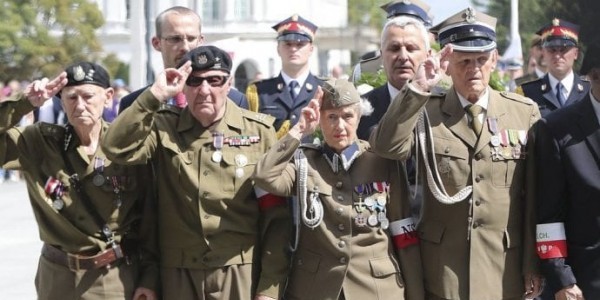 Polish president, ruling party officials pay tribute to wartime force in pitch to right-wing voters; country’s chief rabbi calls ceremony ‘dangerous’ historical revisionism